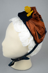 Bonnet, black straw capote trimmed with blue velvet, silk ribbons in blue and dark orange, and artificial flowers, 1880s, side view by Irma G. Bowen Historic Clothing Collection