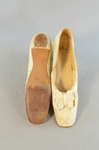 Shoes, white kidskin slippers with pinked bow, 1860s, top and sole view by Irma G. Bowen Historic Clothing Collection