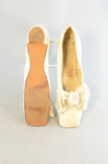 Shoes, white kidskin slippers with ribbon bow, 1860s-1870s, top and sole view by Irma G. Bowen Historic Clothing Collection