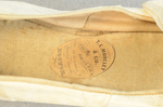 Shoes, white kidskin slippers with ribbon bow, 1860s-1870s, detail of label by Irma G. Bowen Historic Clothing Collection