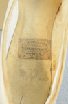 Shoes, white kidskin slippers with kidskin bow, 1879, detail of label by Irma G. Bowen Historic Clothing Collection