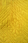 Quilted petticoat, yellow silk, 18th century, detail of quilted flower by Irma G. Bowen Historic Clothing Collection