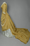 Dress, deep yellow silk taffeta with blue silk satin pleats and long train, 1877-1882, side view with restored seams and darts by Irma G. Bowen Historic Clothing Collection