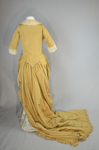 Dress, deep yellow silk taffeta with blue silk satin pleats and long train,1877-1882, back view with seams let out by Irma G. Bowen Historic Clothing Collection