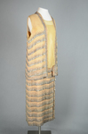 Sheath dress with vest, sleeveless, pale gold and tangerine chiffon with rows of bugle beads, c. 1923, quarter view by Irma G. Bowen Historic Clothing Collection