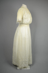 Dress, machine embroidered white muslin with a lace yoke and sleeves, c. 1905-1910, side view by Irma G. Bowen Historic Clothing Collection