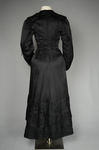 Suit, black ottoman silk trimmed with Maltese crosses and tassels of silk-wrapped beads, 1915-1917, back view by Irma G. Bowen Historic Clothing Collection