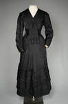 Suit, black ottoman silk trimmed with Maltese crosses and tassels of silk-wrapped beads, 1915-1917, front view by Irma G. Bowen Historic Clothing Collection
