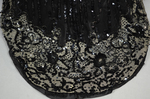 Evening gown, Marie Lamy of Paris, black silk satin with a black-sequined overlay and short puffed sleeves, 1890s, detail of train by Irma G. Bowen Historic Clothing Collection