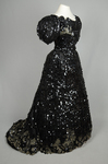 Evening gown, Marie Lamy of Paris, black silk satin with a black-sequined overlay and short puffed sleeves, 1890s, quarter view