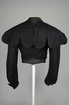 Jacket, black wool with large scalloped revers, pouched front, and topstitched silk trim c. 1902, back view by Irma G. Bowen Historic Clothing Collection