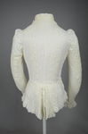 Shirtwaist, white embroidered cotton with ruffles flanking the buttoned front, 1884, back view by Irma G. Bowen Historic Clothing Collection
