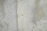 Shirtwaist, white embroidered cotton with ruffles flanking the buttoned front, 1884, detail of button and embroidery by Irma G. Bowen Historic Clothing Collection