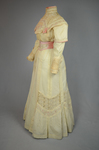 Dress, cream wool trimmed with lace, pink velvet, and multi-colored machine embroidery, 1908, quarter view by Irma G. Bowen Historic Clothing Collection