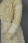 Dress, House of Rouff, cream wool with lace-draped bodice and sleeves, trimmed with cording, ribbon fronds, and roses, c. 1905, detail of sleeve by Irma G. Bowen Historic Clothing Collection
