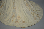 Dress, House of Rouff, cream wool with lace-draped bodice and sleeves, trimmed with cording, ribbon fronds, and roses, c. 1905, detail of train by Irma G. Bowen Historic Clothing Collection