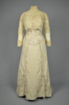 Dress, House of Rouff, cream wool with lace-draped bodice and sleeves, trimmed with cording, ribbon fronds, and roses, c. 1905, front view by Irma G. Bowen Historic Clothing Collection