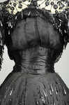 Evening gown, House of Rouff, black silk taffeta with layered black net overlays embroidered with elongated black spangles and round sequins, c. 1905, detail of chiffon puff and satin sash by Irma G. Bowen Historic Clothing Collection
