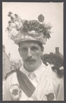 Morris dancer with floral hat and mustache
