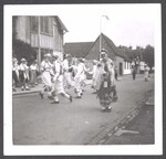 Morris team dancing in the street with Fool
