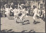 Morris dancers wearing bowler hats performing outdoors