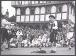 Two Morris dancers performing alongside an accordian player