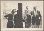 Three woman and two men standing outside entrance Pinewoods Camp dining hall