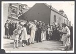 Crowd gathers around musicians, Fool, and hobby horse