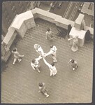 Four male and four female Morris dancers on a rooftop