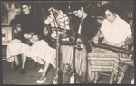 Four women playing the mountain dulcimer indoors