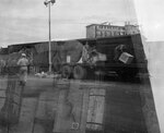 Double exposure of soldiers unloading a train car and a singular soldier pointing at a wooden crate by Unknown