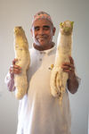 Bhutanese Man with Daikon Radishes, 2012 by Becky Field