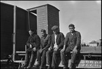 Four workers seated on construction materials in Michurinsk, Russia, USSR, ca. 1932-1933 by Jacobi, Lotte, 1896-1990