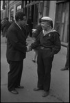 Egon Erwin Kisch, an Austrian and Czechoslovakian writer and jourlist shaking hands with a sailor on a street in Moscow, Russia, USSR, ca. 1932 by Jacobi, Lotte, 1896-1990