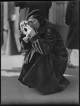 Helen Elliot taking a photo on a street in Moscow, Russia, USSR, ca. 1932 by Jacobi, Lotte, 1896-1990