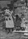 Portrait of the Fedja family standing in front of a crumbling wall in Moscow, Russia, USSR, ca. 1932-1933 by Jacobi, Lotte, 1896-1990