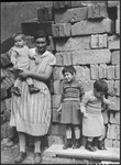 Portrait of the Fedja family standing in front of a crumbling wall in Moscow, Russia, USSR, ca. 1932-1933 by Jacobi, Lotte, 1896-1990