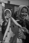 Woman holding up an embroidered cloth at a marketplace in Moscow, Russia, USSR, ca. 1932-1933 by Jacobi, Lotte, 1896-1990