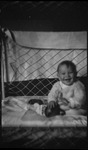 A baby in the Dietrich family smiling in a crib in Moscow, Russia, USSR, ca. 1932-1933 by Jacobi, Lotte, 1896-1990