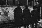 Three men standing by a train car in the USSR, ca. 1932-1933 by Jacobi, Lotte, 1896-1990