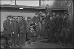 Group of primarily young men and women posed around a junk car in the USSR, ca. 1932-1933 by Jacobi, Lotte, 1896-1990