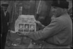 Man on the street holding a paper in Russia, USSR, ca. 1932-1933 by Jacobi, Lotte, 1896-1990