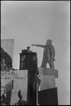 Man speaking from a tall podium at a November holiday gathering in Stalinabad (Dushanbe), Tajikistan, Central Asia, ca. 1932-1933 by Jacobi, Lotte, 1896-1990