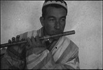 Flute player in Stalinabad (Dushanbe), Tajikistan, Central Asia, ca. 1932 by Jacobi, Lotte, 1896-1990