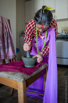 Bhutanese Woman with Mortar and Pestle by Becky Field