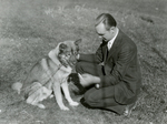 Herbert Jackson in yard with dog, 1932 by Clement Moran