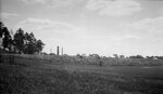 Railroad bed with smoke stack in distance viewed from the athletic fields area, August 19, 1924 by Pond, Bremer Whidden, 1884-1959