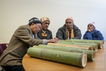 Bhutanese Men Inspecting Bamboo Shipment, 2014 by Becky Field