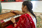Nepali Girl Playing Harmonium, 2016 by Becky Field